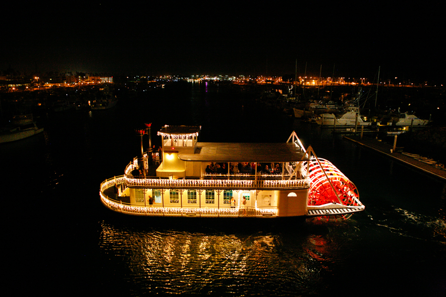The Scarlett Belle paddle wheeler lit up at night in Channel Islands Harbor
